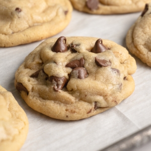 cooling soft and chewy chocolate chip cookies on a baking sheet