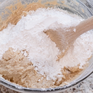 folding dry cookie dough mixture into wet cookie dough mixture