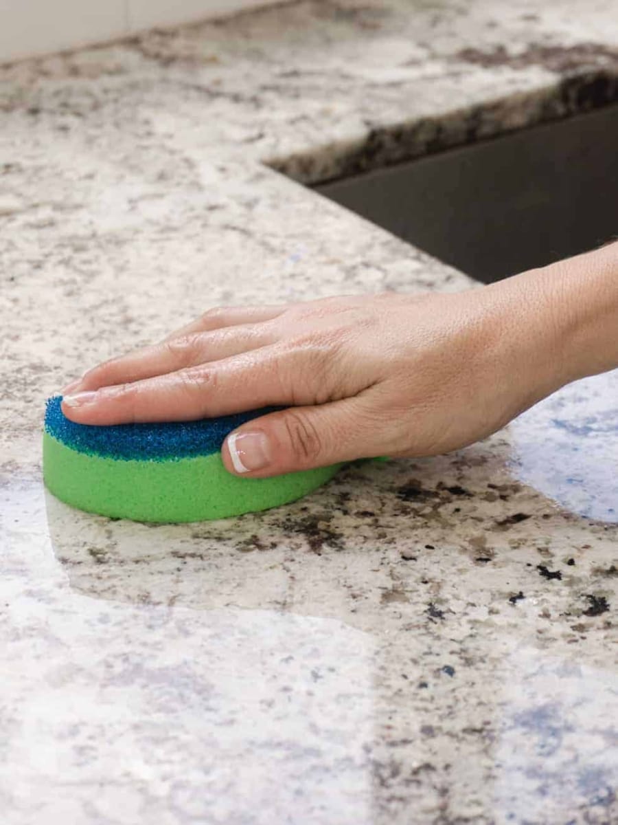 cleaning countertops with dish sponge