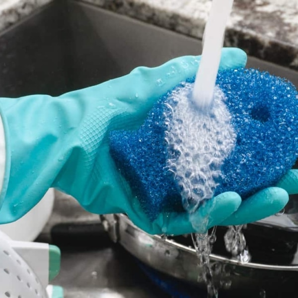 running water over the dish fish sponge