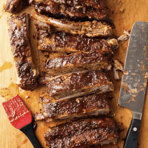 glazed baby back ribs on a wooden board