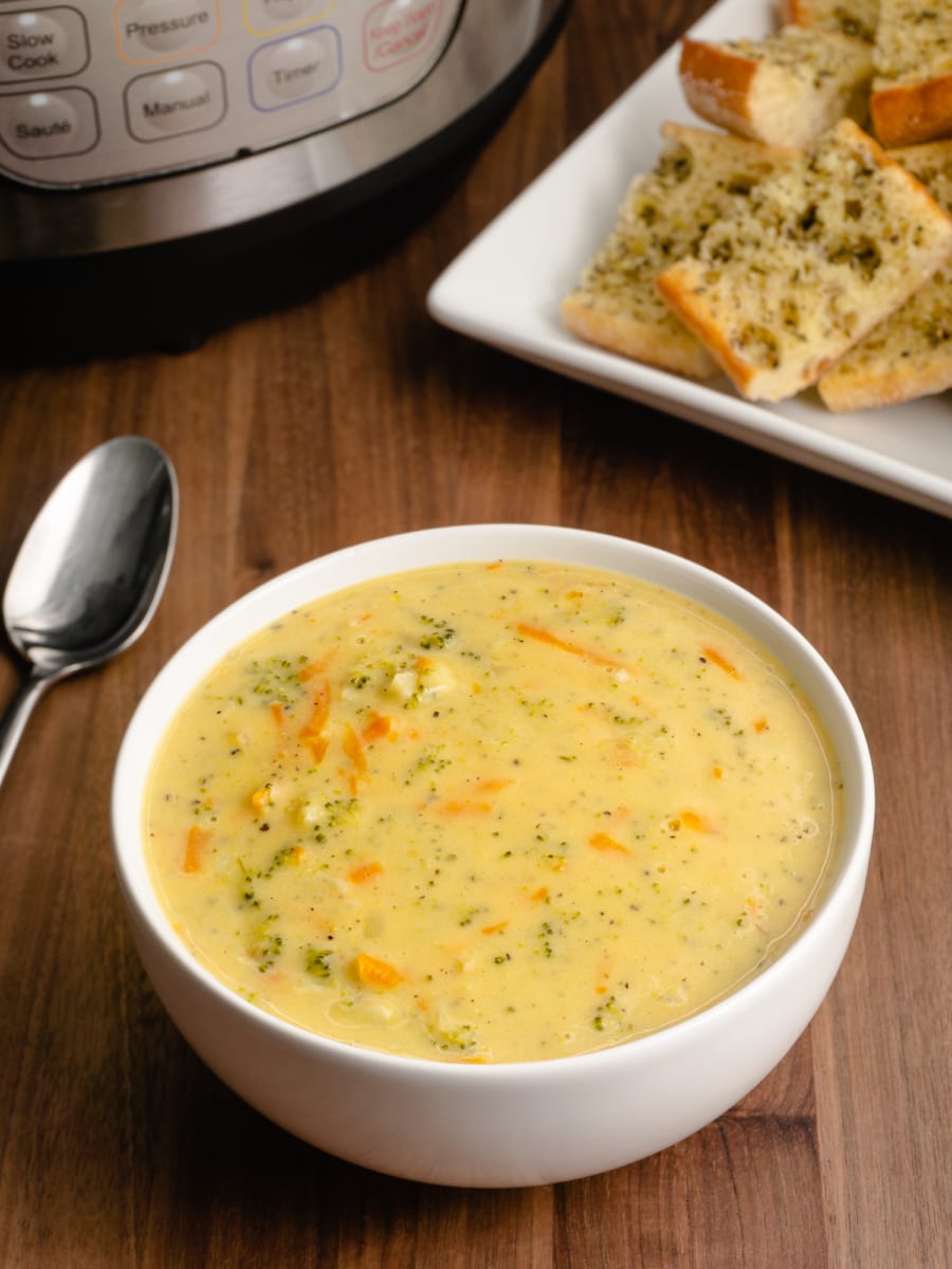 a bowl of cheddar broccoli soup on a counter