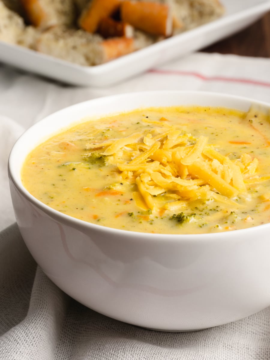 side view of broccoli cheese soup in a bowl