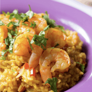 close up of shrimp paella garnished with cilantro