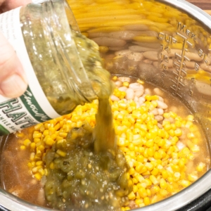 adding salsa verde to the instant pot for making white chicken chili