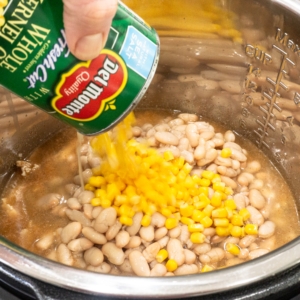 adding whole kernel corn to the instant pot for making white chicken chili