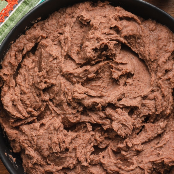 overhead shot of authentic refried beans in a large bowl