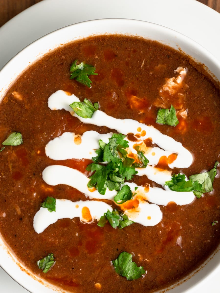 instant pot bean soup with egg and topped with crema and cilantro