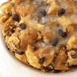 close up of bread pudding glazed and topped with raisins