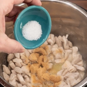 adding salt to season chicken in the pressure cooker