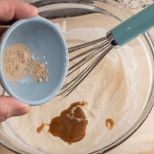 adding white pepper to give the alfredo sauce a little spicy kick