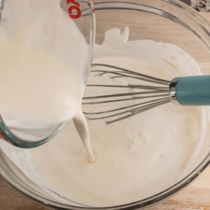 adding more heavy cream to a sauce base to make alfredo sauce