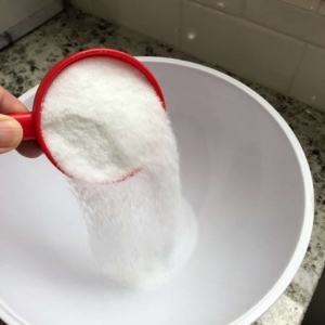 adding salt to a medium sized mixing bowl to make a brine