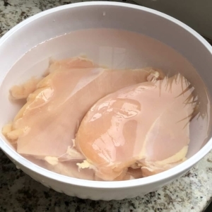 allowing chicken breasts to brine for 15 minutes in a mixture of salt and water