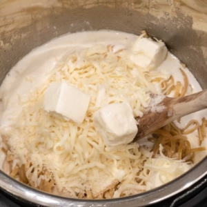 linguine pasta and chicken with alfredo sauce base, parmesan cheese, mozzarella cheese, and cream cheese