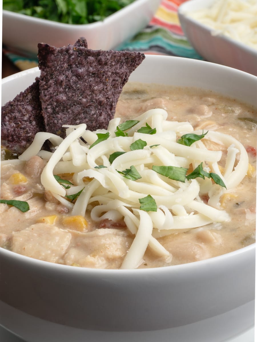 instant pot white bean chicken chili topped with chips and cheese