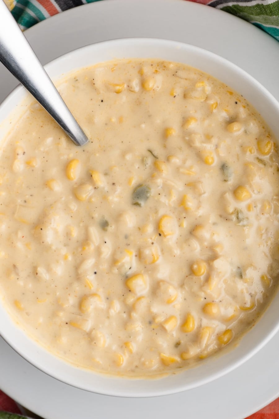 a view from above of a bowl of instant pot vanilla jalapeño corn chowder with a spoon