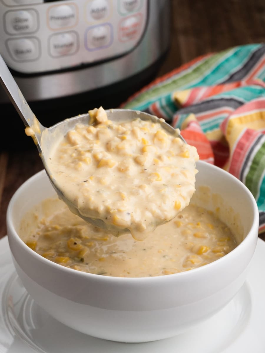 a ladle serving a bowl of some instant pot creamy vanilla jalapeño corn chowder