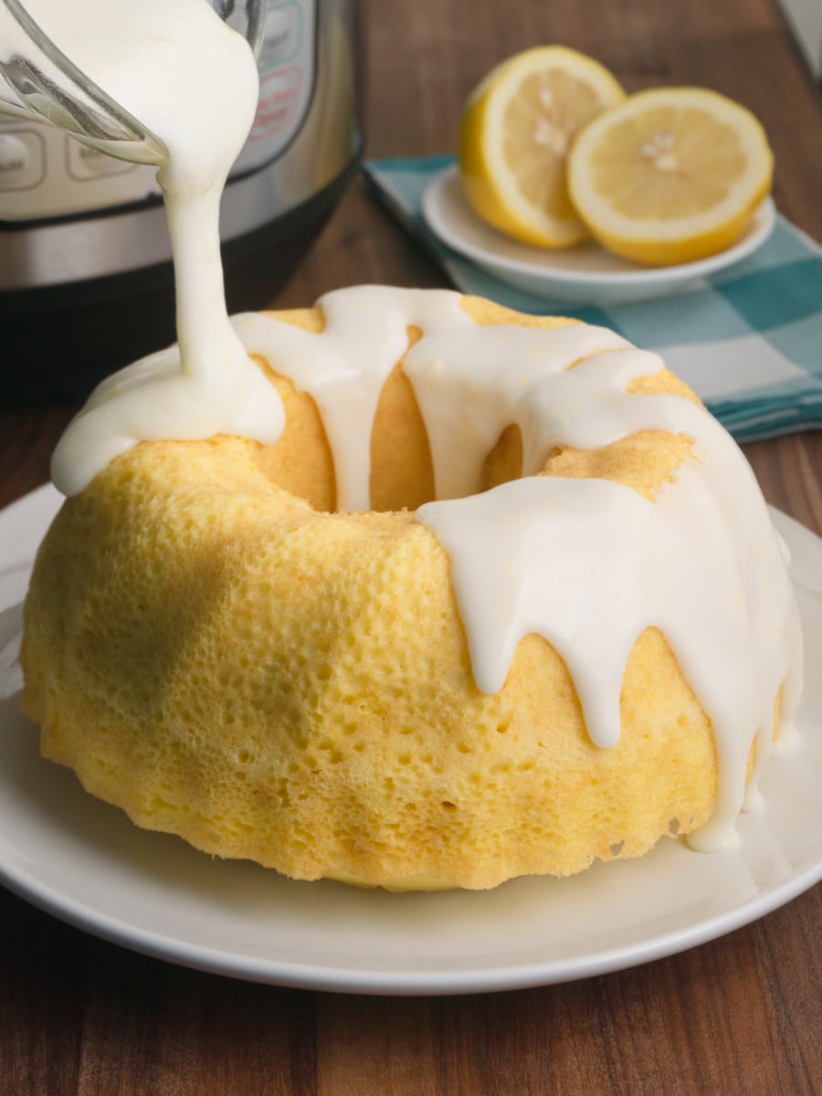 delicious and creamy homemade lemon glaze being poured over an instant pot lemon bundt cake