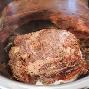 a seasoned chuck roast in the instant pot before cooking