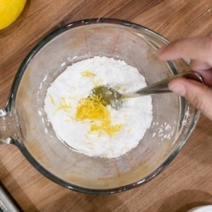 mixing a lemon glaze for a lemon cake