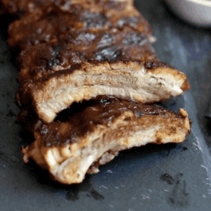 close up of fall off the bone pork ribs evenly spreaded out