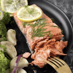 lemon butter salmon on a plate garnished with rosemary