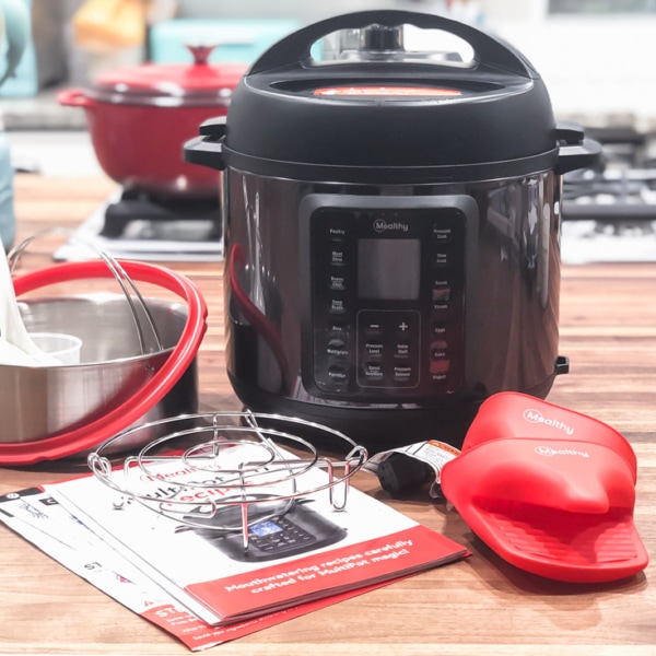 everything that comes in the mealthy multipot 2.0 box including the pressure cooker, mealthy multipot user's manual, silicone mitts, trivet, streamer basket, silicone ring, measuring cup, spoon, and spatula