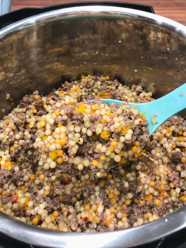 a serving spoonful of couscous made in an electric pressure cooker