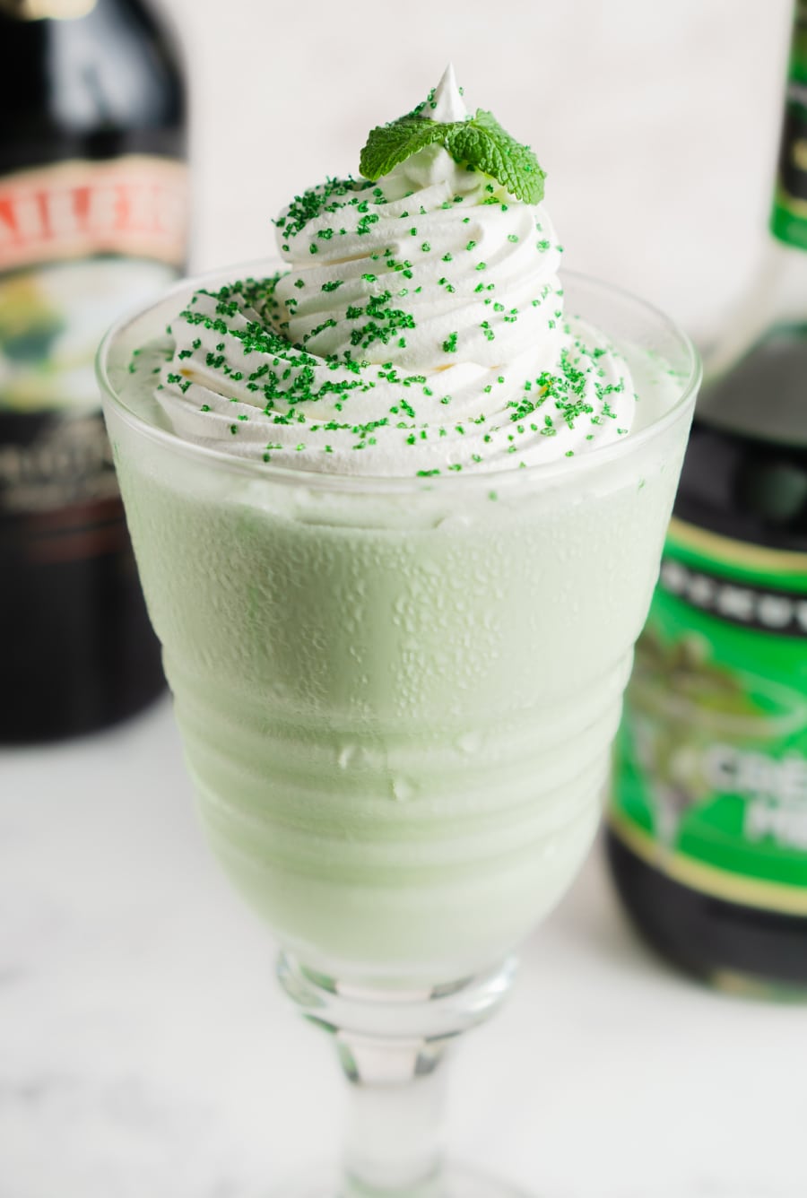 a boozy shamrock shake topped with mint