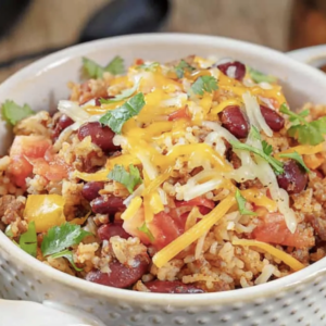 a bowl of mexican ground beef casserole garnished with cilantro