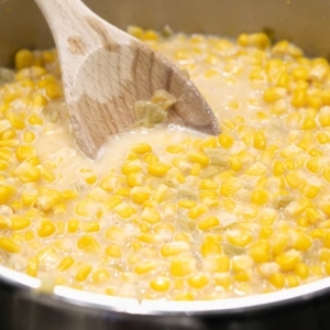 corn, with green chiles, milk, melted butter, sugar, and creole seasoning in a skillet