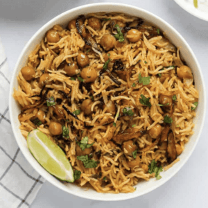 overhead shot of chickpea biryani in a bowl garnished with cilantro