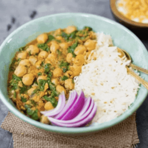 a bowl of spinach chickpea curry served with white rice