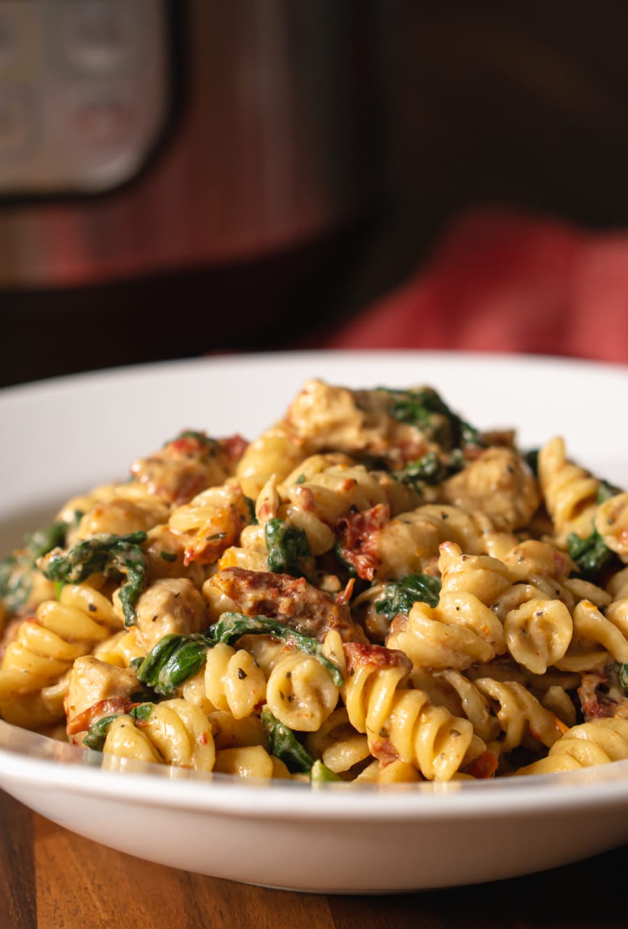 a bowl filled with tuscan chicken pasta