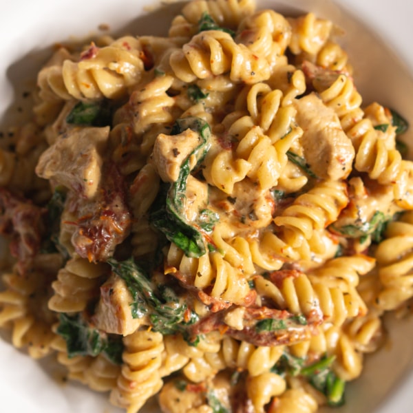 overhead shot of tuscan chicken pasta served on a plate