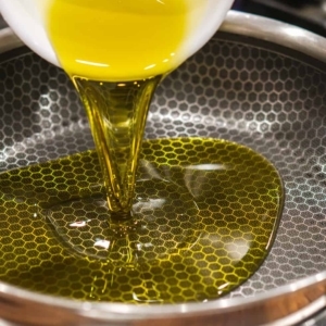 pouring olive oil into a skillet