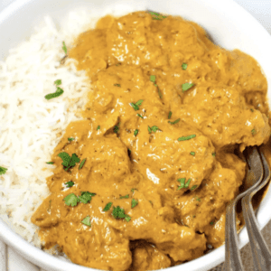 a bowl of chicken curry and white rice