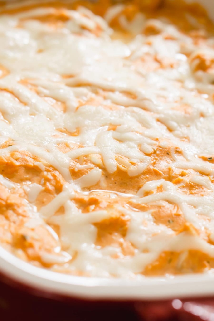 a casserole with buffalo ranch chicken dip with melted mozzarella on top