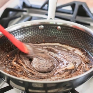 combining melted butter, cocoa powder, and sweetened condensed milk in a skillet