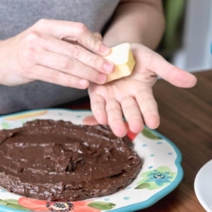 greasing the palms of hands with butter