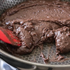 the chocolate base for chocolate brigadeiros in a nonstick skillet on the stove