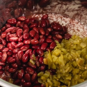 layers of white rice, red kidney beans, and diced green chiles in the instant pot