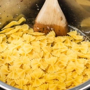 a layer of farfalle pasta sitting in the instant pot