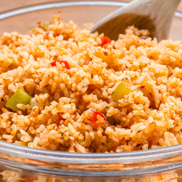 a large glass bowl filled with spanish rice