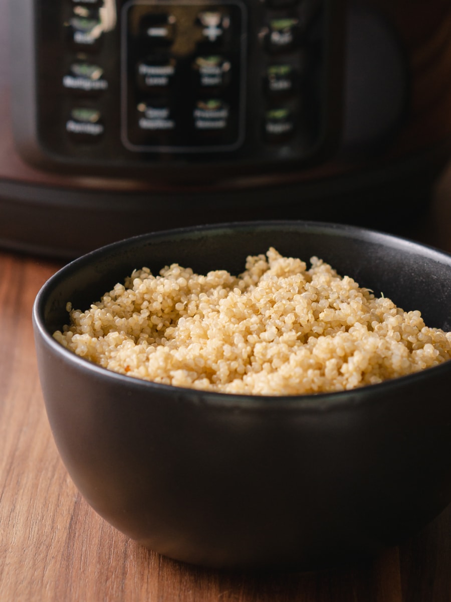 a bowl of quinoa sitting in front of the mealthy pressure cooker