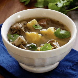 a bowl of pork soup with hatch chiles