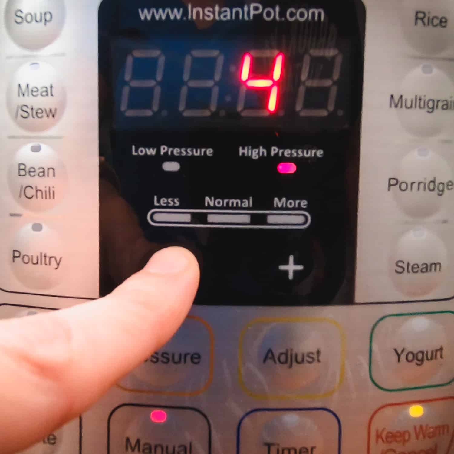 the digital display of the instant pot displaying 4 as the cook time is being adjusted to 4 minutes