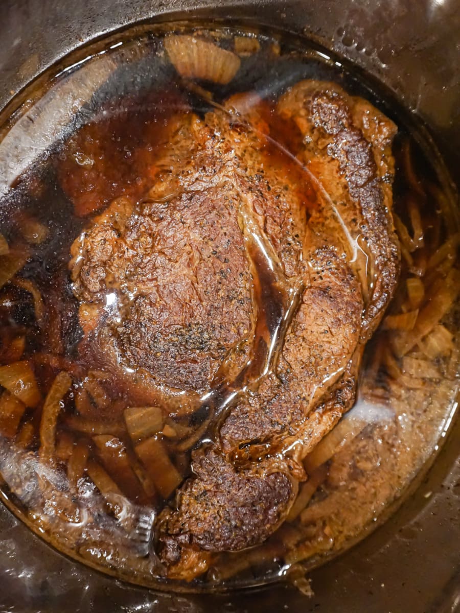 large chuck roast resting in au jus in the instant pot