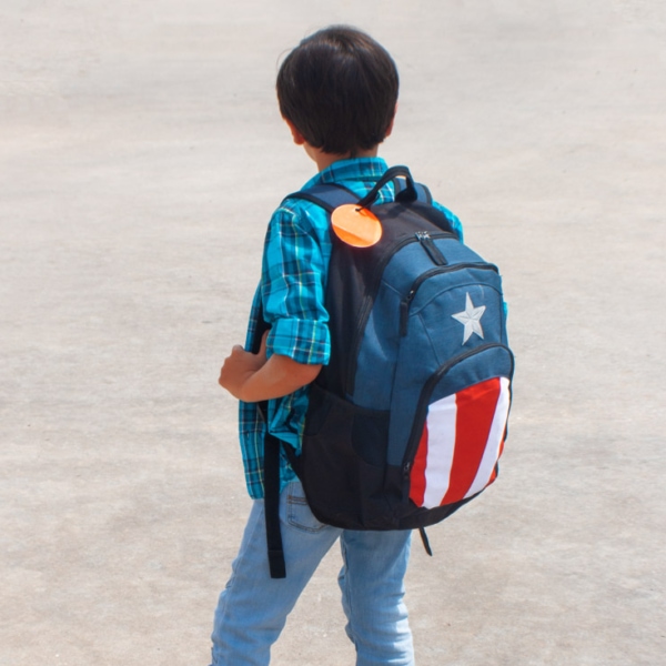 young boy heading back to school with a backpack on his back